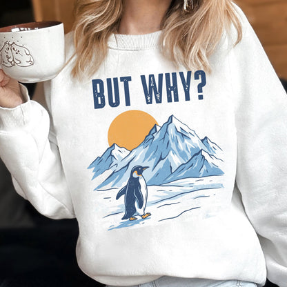 May include: White sweatshirt with the text "BUT WHY?" above a graphic of a penguin walking in front of mountains and a yellow sun. The penguin is black and white, and the mountains are blue.