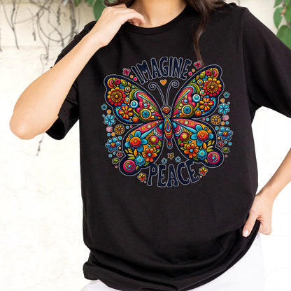 May include: A black short-sleeved t-shirt featuring a large, colorful butterfly graphic composed of intricate floral patterns in shades of red, orange, yellow, and blue. The text "IMAGINE" is arched above the butterfly, and "PEACE" is below it.