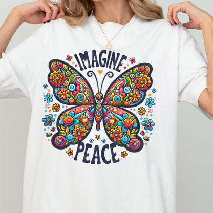 May include: A white short-sleeved t-shirt featuring a large, colorful butterfly graphic with intricate floral patterns in shades of red, orange, yellow, and blue. The text "IMAGINE" is arched above the butterfly, and "PEACE" is printed below it.