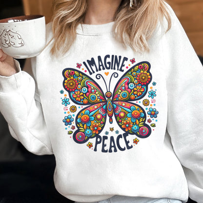 May include: White sweatshirt featuring a colorful butterfly design with the words "IMAGINE PEACE". The butterfly is filled with flowers in shades of blue, orange, yellow, and pink. The sweatshirt is a crew neck style.