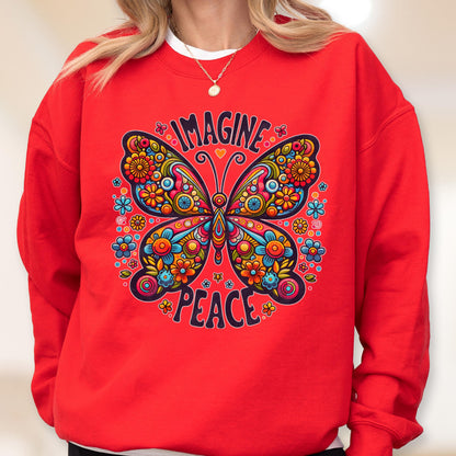 May include: A red sweatshirt featuring a colorful butterfly design with the words "IMAGINE" and "PEACE". The butterfly is decorated with flowers in shades of blue, orange, yellow, and pink. The sweatshirt has a crew neck.