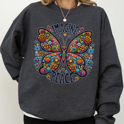 May include: A dark gray sweatshirt featuring a colorful butterfly design with the words "IMAGINE PEACE". The butterfly is decorated with flowers in shades of blue, orange, yellow, and pink. The sweatshirt is a casual style.