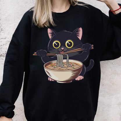 May include: Black sweatshirt featuring a cartoon black cat eating ramen noodles with chopsticks. The cat has large yellow eyes and pink ears and paws. The ramen bowl is beige with a brown rim and contains noodles and broth.