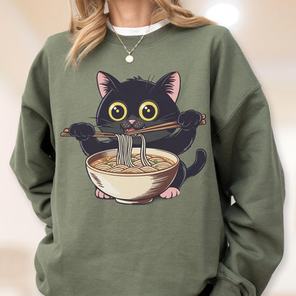 May include: An olive green sweatshirt featuring a cartoon black cat holding chopsticks with noodles from a bowl. The cat has large yellow eyes and pink paws. The design is centered on the front of the sweatshirt.