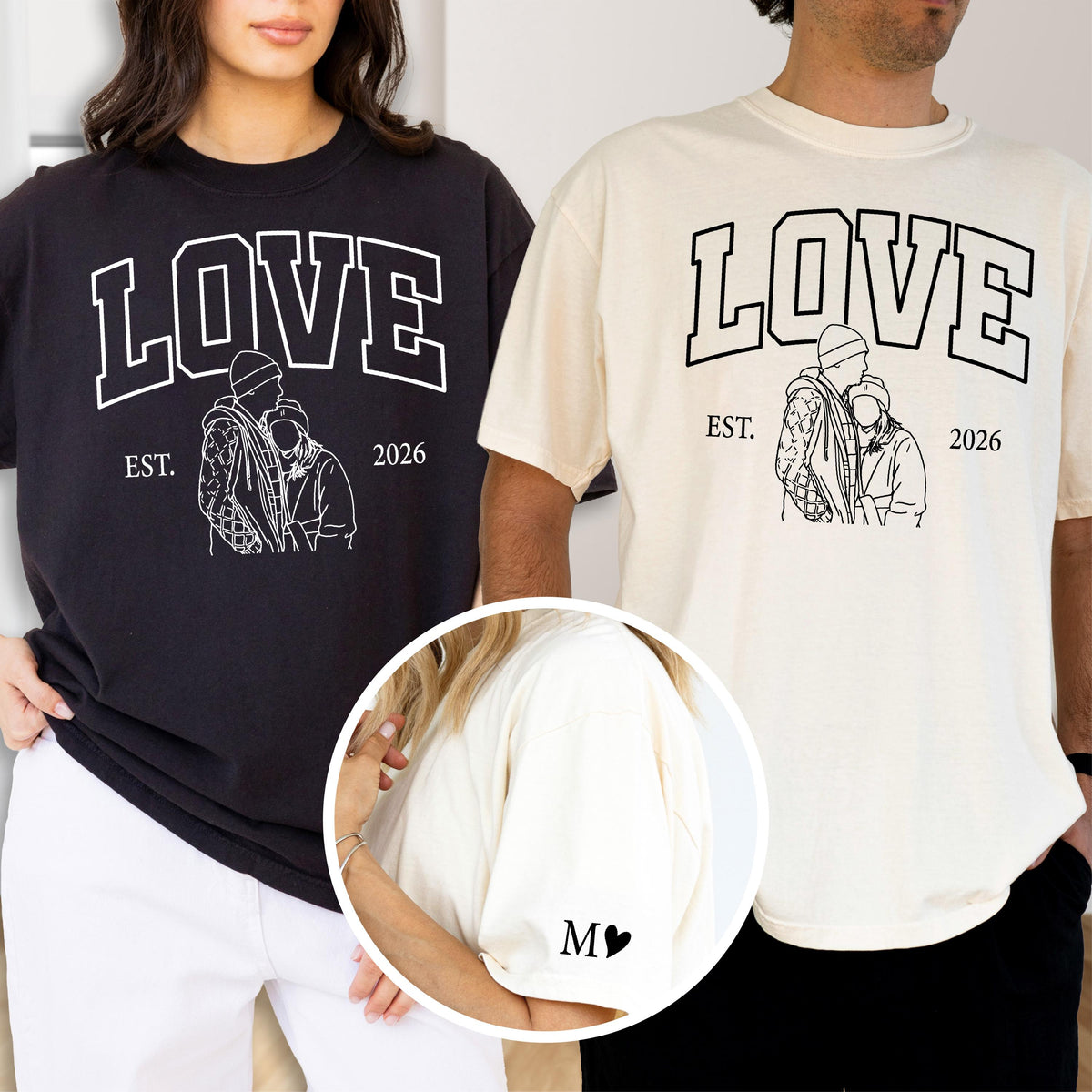 May include: Black and cream-colored t-shirts with the word "LOVE" in a bold, white, collegiate-style font. Below the word "LOVE" is a line drawing of two people embracing, with the text "EST. 2026". The left shirt is black, and the right shirt is cream.