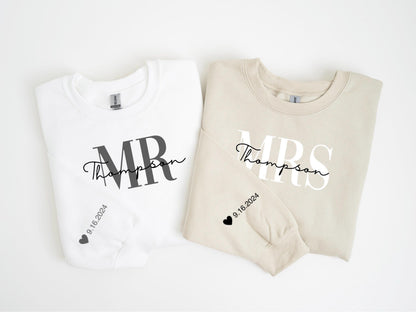 May include: Two matching sweatshirts, one white and one beige, with wedding-themed text. The white sweatshirt says "MR Thompson" in black script and block letters. The beige sweatshirt says "MRS Thompson". Both have the date "9.16.2024" and a heart.