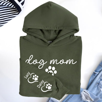 May include: An olive green hoodie with the words "dog mom" in white script. The sleeve features paw prints and the names "Lucy" and "Daisy". The hoodie is made of a soft material and has a hood.