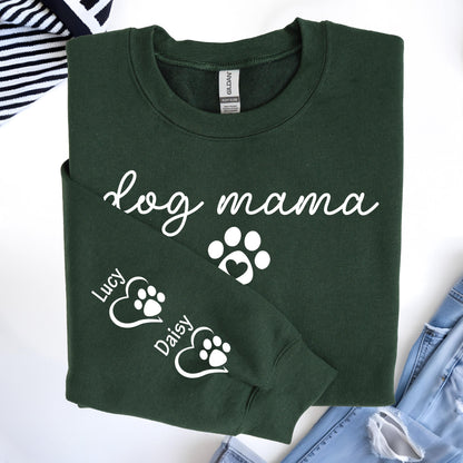 May include: Dark green sweatshirt with the words "dog mama" in white script. A white paw print with a heart is below the text. The sleeve has two paw prints with the names "Lucy" and "Daisy".