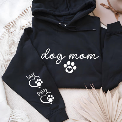 May include: Black hoodie with the words "dog mom" in white script, a paw print with a heart, and the names "Lucy" and "Daisy" with paw prints on the sleeve. The hoodie has a drawstring hood.