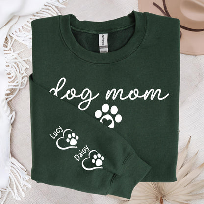 May include: Dark green sweatshirt with the words "dog mom" in white script, along with paw print graphics. The sleeve features paw prints inside hearts with the names "Lucy" and "Daisy".