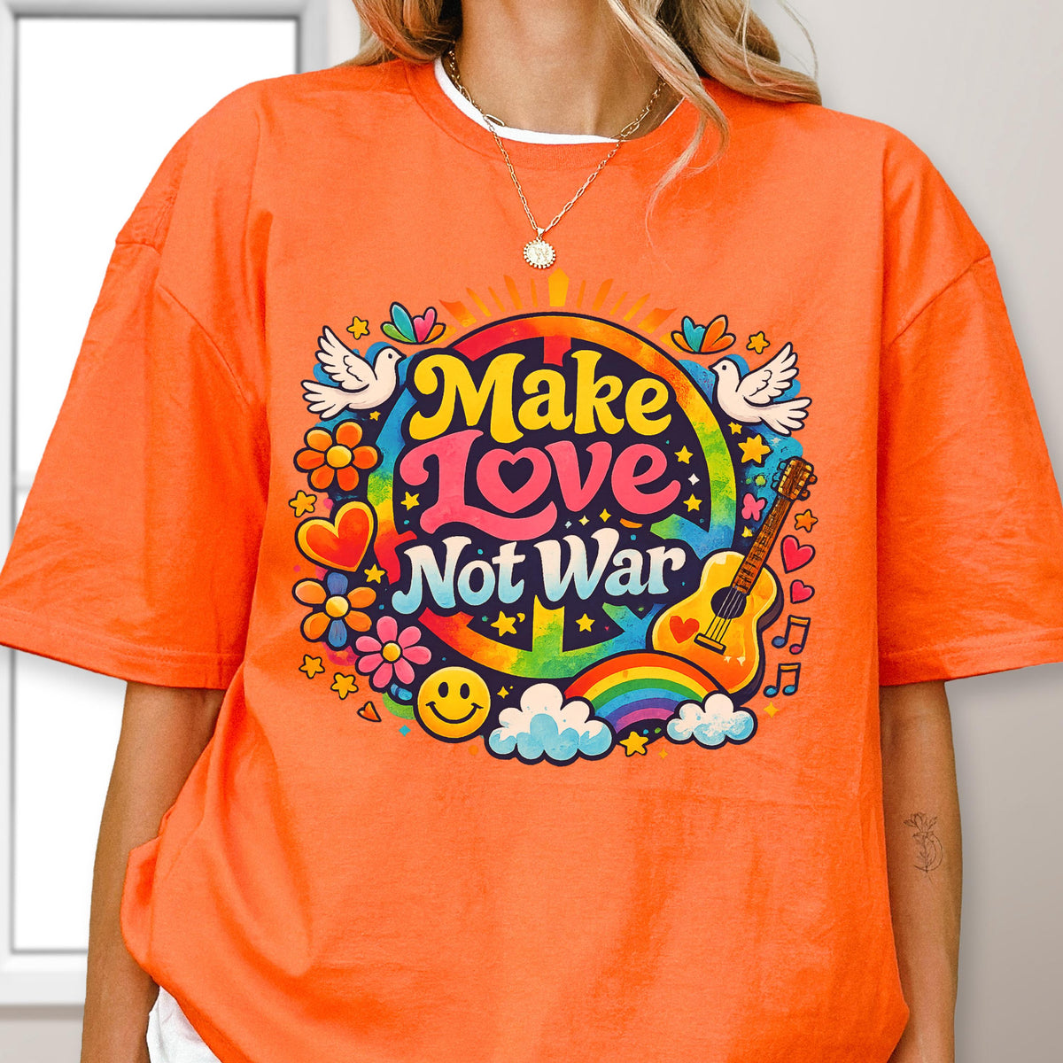 May include: Orange t-shirt with a colorful "Make Love Not War" graphic. The design includes a rainbow, guitar, flowers, doves, and a smiley face. The shirt is a casual, unisex style.