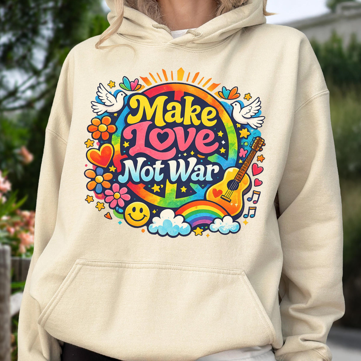 May include: A beige hoodie with a colorful graphic that says "Make Love Not War." The design includes a rainbow, guitar, flowers, doves, and a smiley face. The hoodie has a drawstring hood and a front pocket.