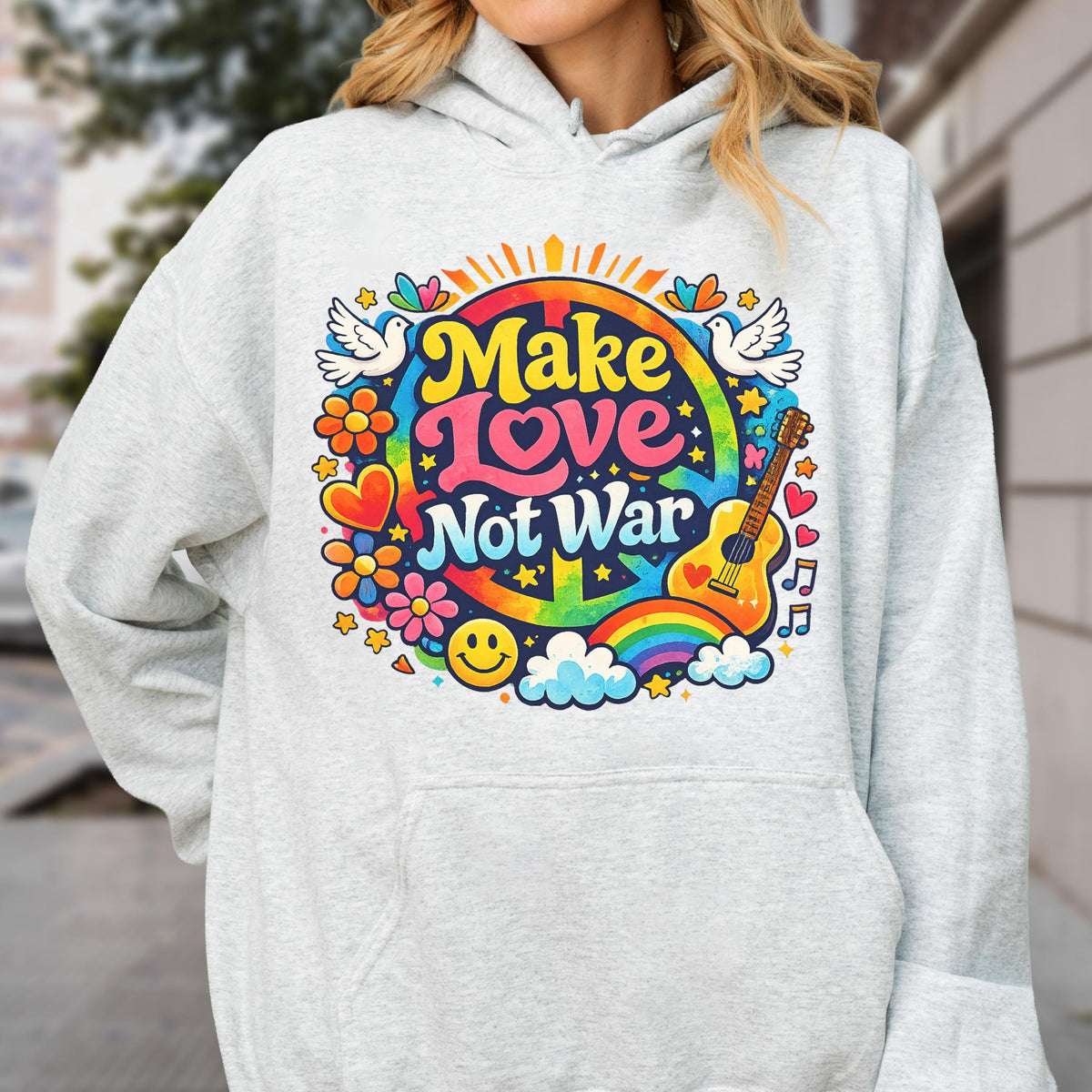 May include: A light gray hoodie featuring a colorful graphic with the text "Make Love Not War." The design includes a peace sign, rainbow, guitar, flowers, doves, and a smiley face. The hoodie has a drawstring hood.