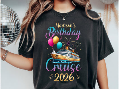 May include: Black t-shirt with a colorful graphic design for a birthday cruise in 2026. The design includes a cruise ship, balloons, fireworks, and the text "Madison's Birthday Cruise 2026."
