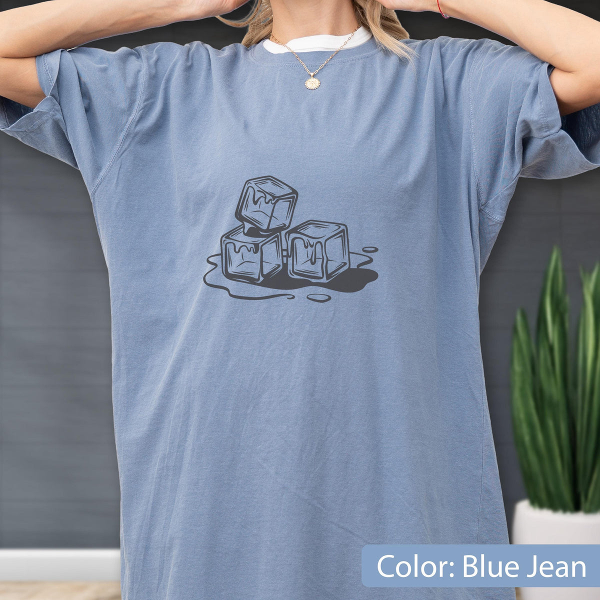May include: Blue jean colored t-shirt with a graphic of three melting ice cubes. The shirt has short sleeves and a relaxed fit. The text "Color: Blue Jean" is at the bottom of the image.