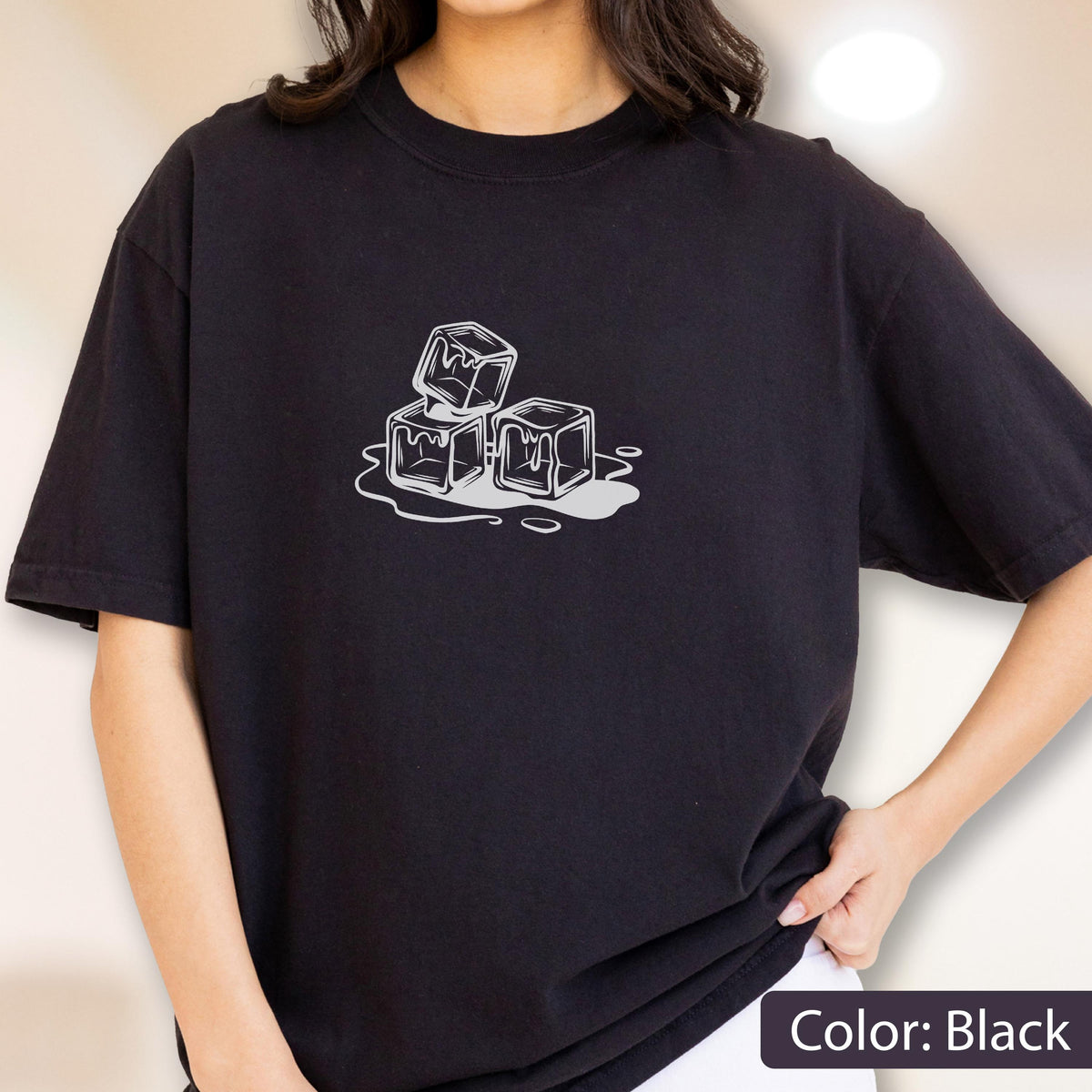 May include: Black t-shirt featuring a white graphic of three melting ice cubes. The design is centered on the chest. The text "Color: Black" is at the bottom right corner of the image.