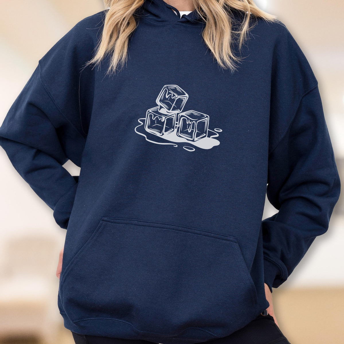 May include: Navy blue hoodie with a white graphic of three melting ice cubes. The hoodie has a front pocket and a drawstring hood. The design is centered on the chest.