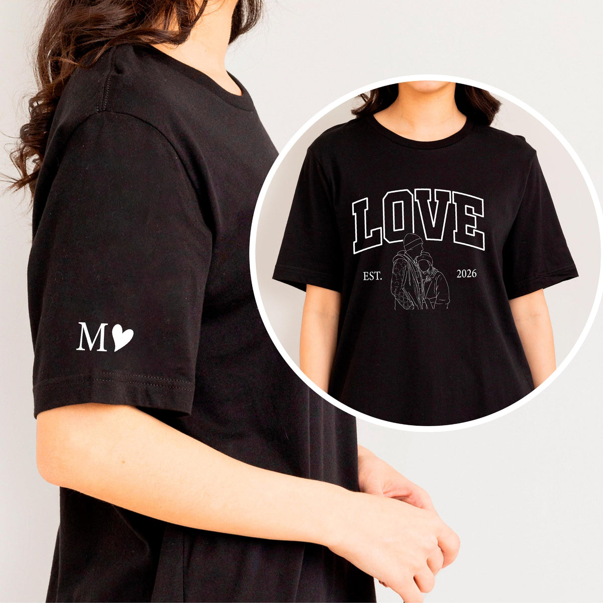 May include: Black t-shirt with white text and graphic. The word "LOVE" is printed across the chest, with "EST. 2026" below a line drawing of two people. The left sleeve has the letter "M" and a heart.