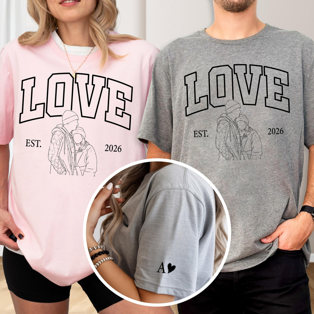 May include: Pink and gray t-shirts with the word "LOVE" in a bold, black, collegiate-style font. Each shirt features a line drawing of a couple and the text "EST. 2026". One shirt has the letter "A" and a heart on the sleeve.