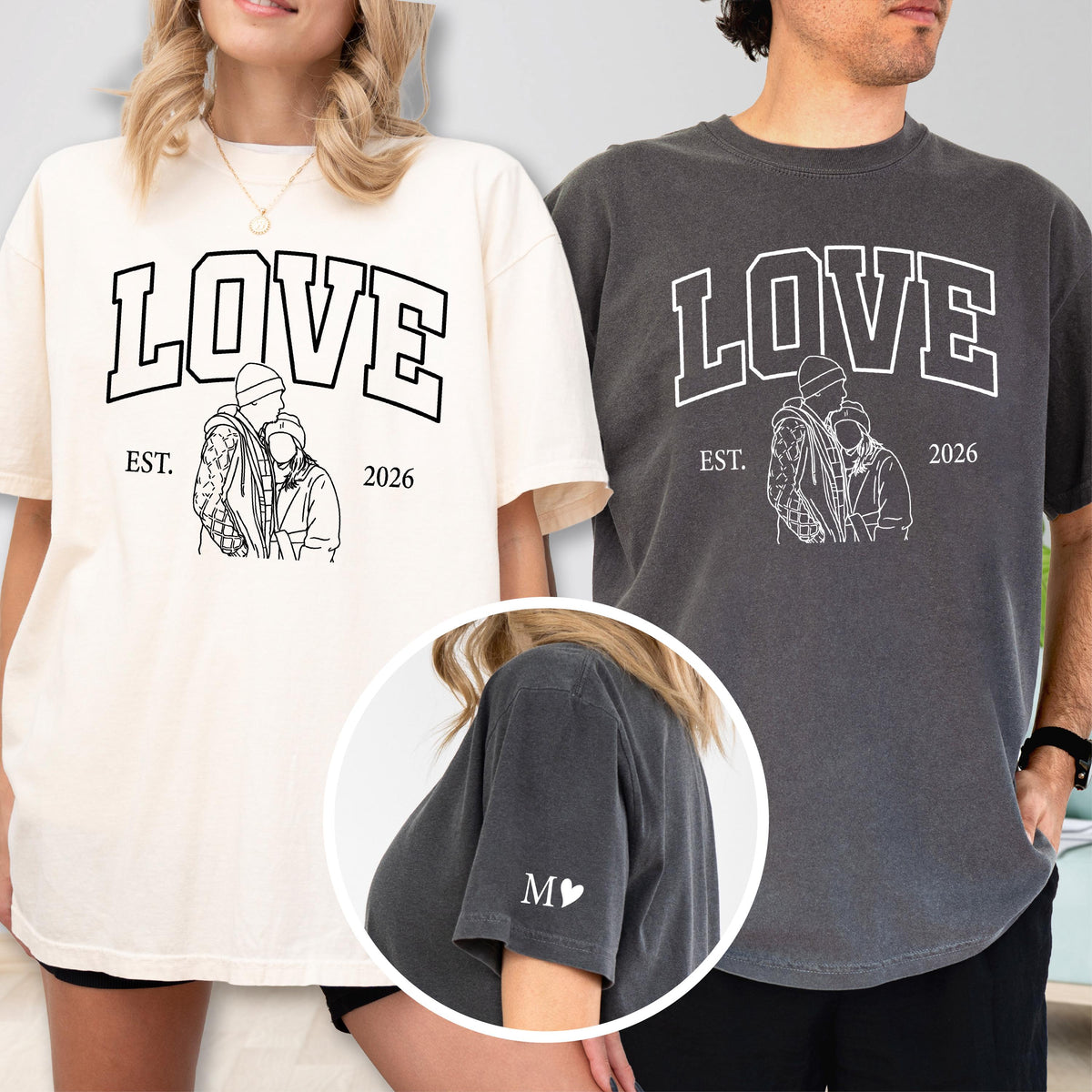 May include: Two short-sleeved t-shirts, one cream and one charcoal, each with the word "LOVE" in bold white letters. Below the word is a line drawing of a couple, the word "EST." and the year "2026". The charcoal shirt has the letter "M" and a heart on the sleeve.