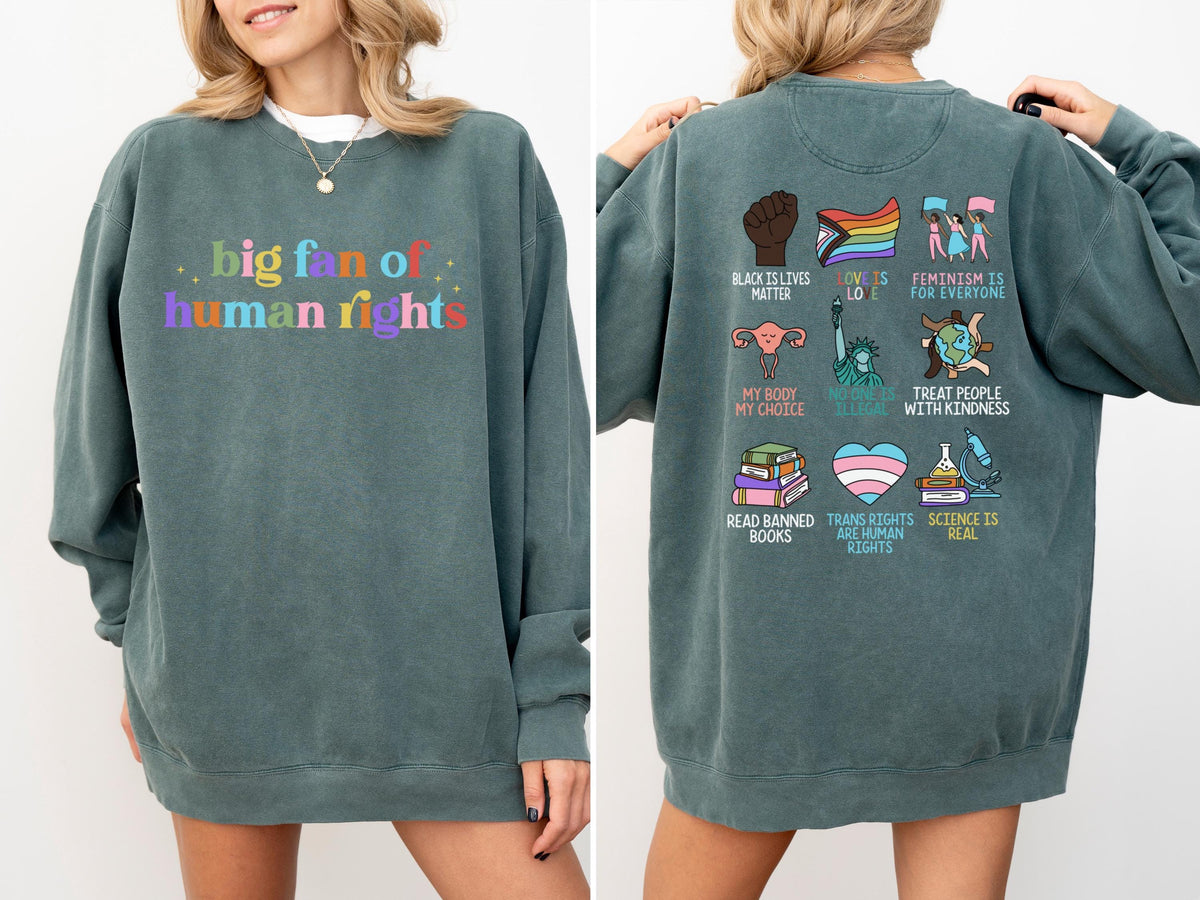 May include: A teal-colored sweatshirt with the text "big fan of human rights" in colorful letters on the front. The back features various graphics and phrases, including "Black Lives Matter," "Love is Love," and "Trans Rights are Human Rights."
