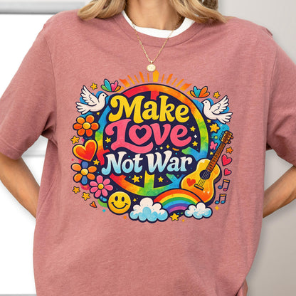 May include: A dusty rose t-shirt featuring a colorful graphic with the words "Make Love Not War." The design includes a rainbow, guitar, doves, flowers, and a smiley face, evoking a retro, peace-loving theme.