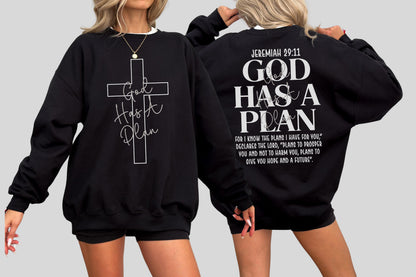 May include: Black sweatshirt with white text and a cross design. The front features a cross with "God Has A Plan" written inside. The back displays "Jeremiah 29:11" and the phrase "God Has A Plan" with a Bible verse.