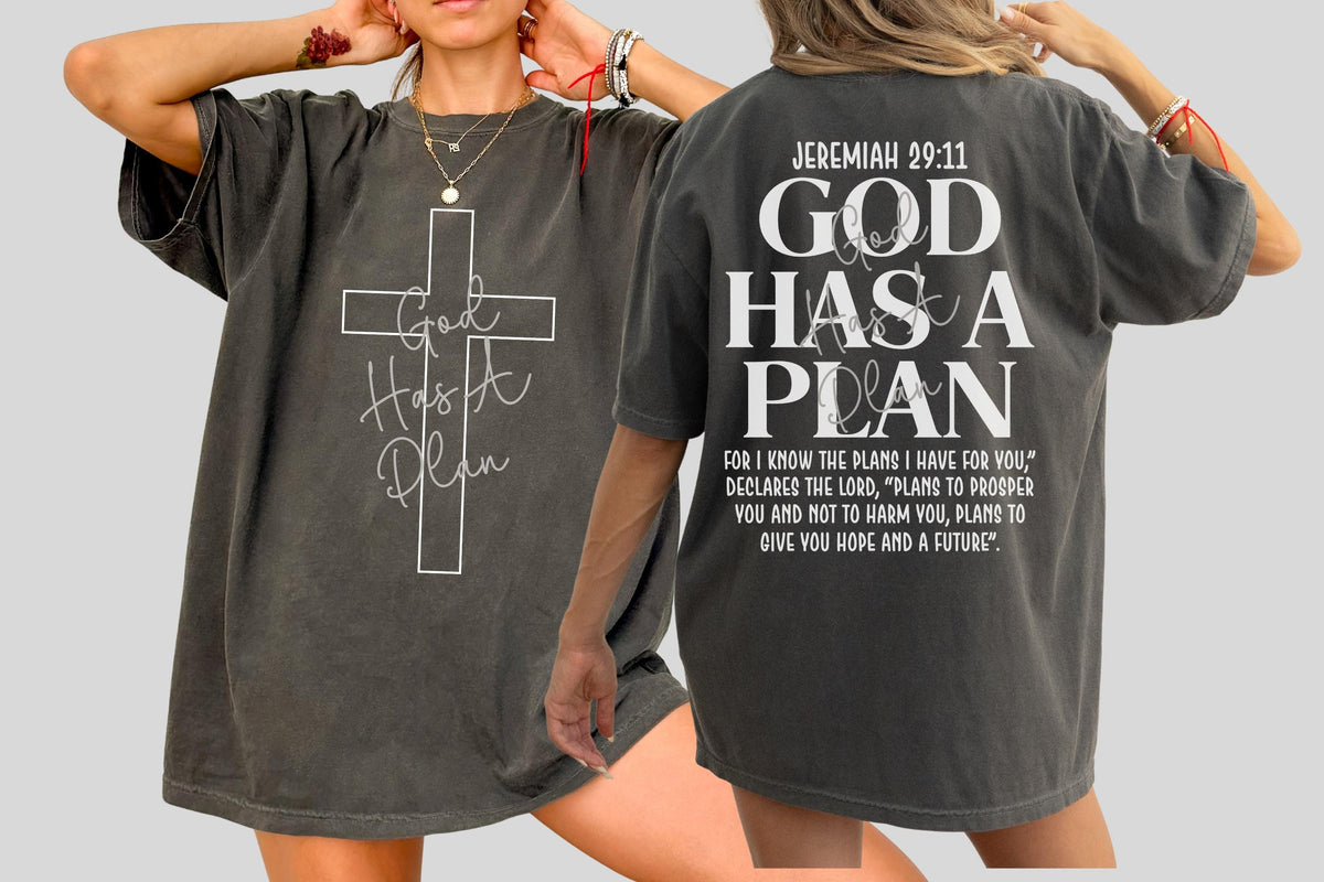 May include: Dark gray t-shirt with a white cross and the words "God Has A Plan" on the front. The back of the shirt features the text "Jeremiah 29:11" and the words "God Has A Plan".