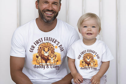 May include: White t-shirts with a lion graphic, the text "OUR FIRST FATHER'S DAY", and the names "daddy & Liam". The shirts feature a cartoon lion family. The shirts are for a father and child.