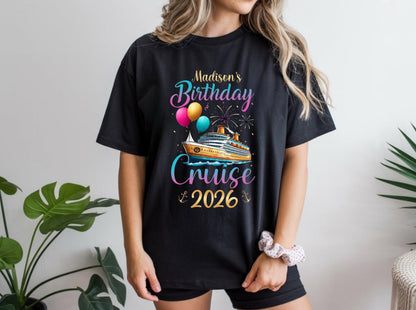 May include: Black t-shirt with a colorful graphic design. The design features a cruise ship, balloons, fireworks, and the text "Madison's Birthday Cruise 2026". The shirt is a casual style.