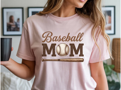 May include: A light pink t-shirt with the words "Baseball MOM" in brown lettering. A baseball and bat graphic are below the text. The shirt is a short-sleeved crew neck.