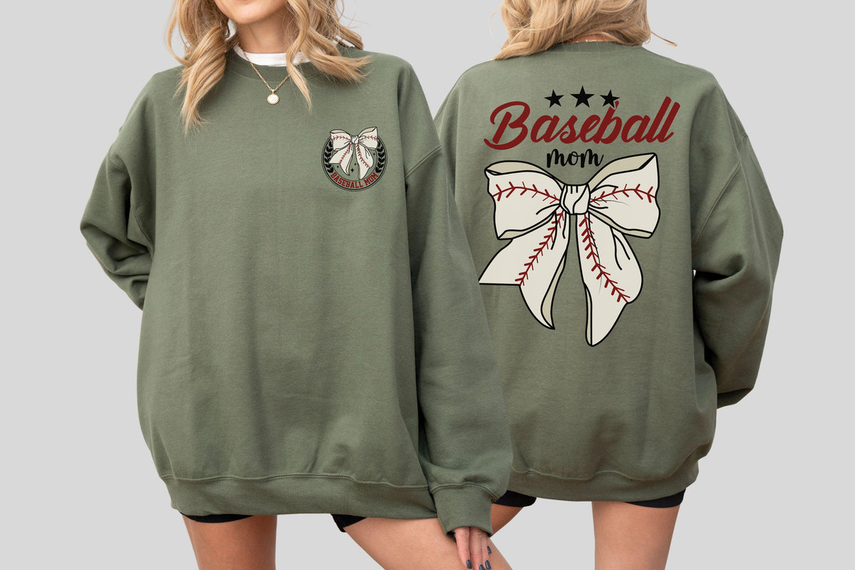 May include: Olive green sweatshirt with a baseball bow graphic on the front and back. The back of the sweatshirt features the words "Baseball mom" in a script font, with three stars above the bow. The bow design resembles a baseball.