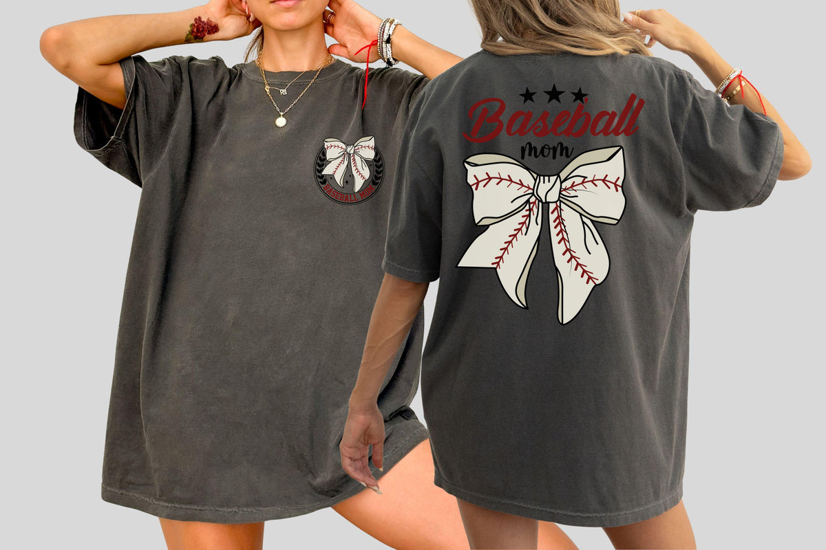 May include: Dark gray oversized t-shirt featuring a baseball-themed design. The front has a bow graphic with a baseball stitch design. The back of the shirt has the words "Baseball mom" with a bow graphic.