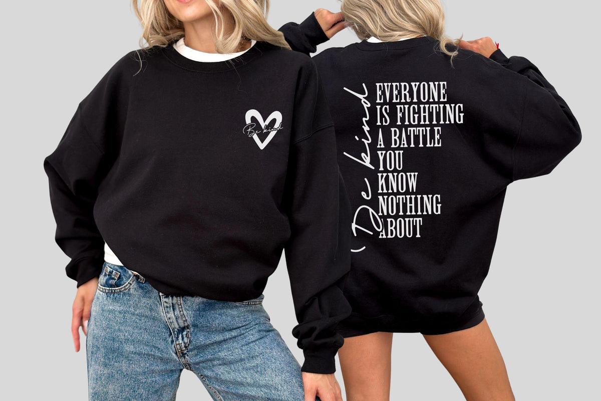 May include: Black sweatshirt with white text and a heart design. The front features a heart with script inside, while the back displays the message "Everyone is fighting a battle you know nothing about" and the word "Be Kind".