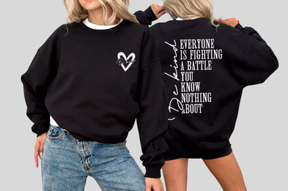 May include: Black sweatshirt with white text and a heart design. The front features a heart with script inside, while the back displays the message "Everyone is fighting a battle you know nothing about" and the word "Be Kind".