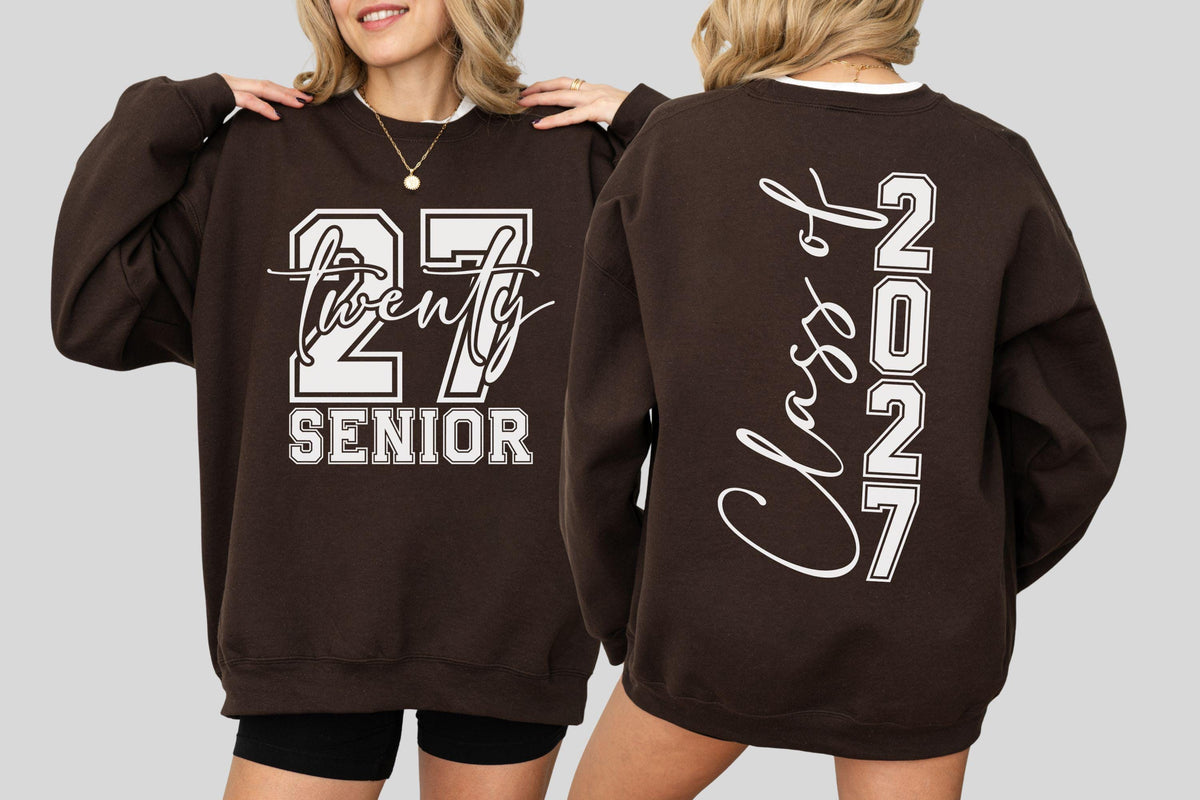 May include: A brown sweatshirt with white lettering. The front displays "27 Twenty SENIOR" in a collegiate style. The back features "Class of 2027" vertically. The sweatshirt has a white collar.