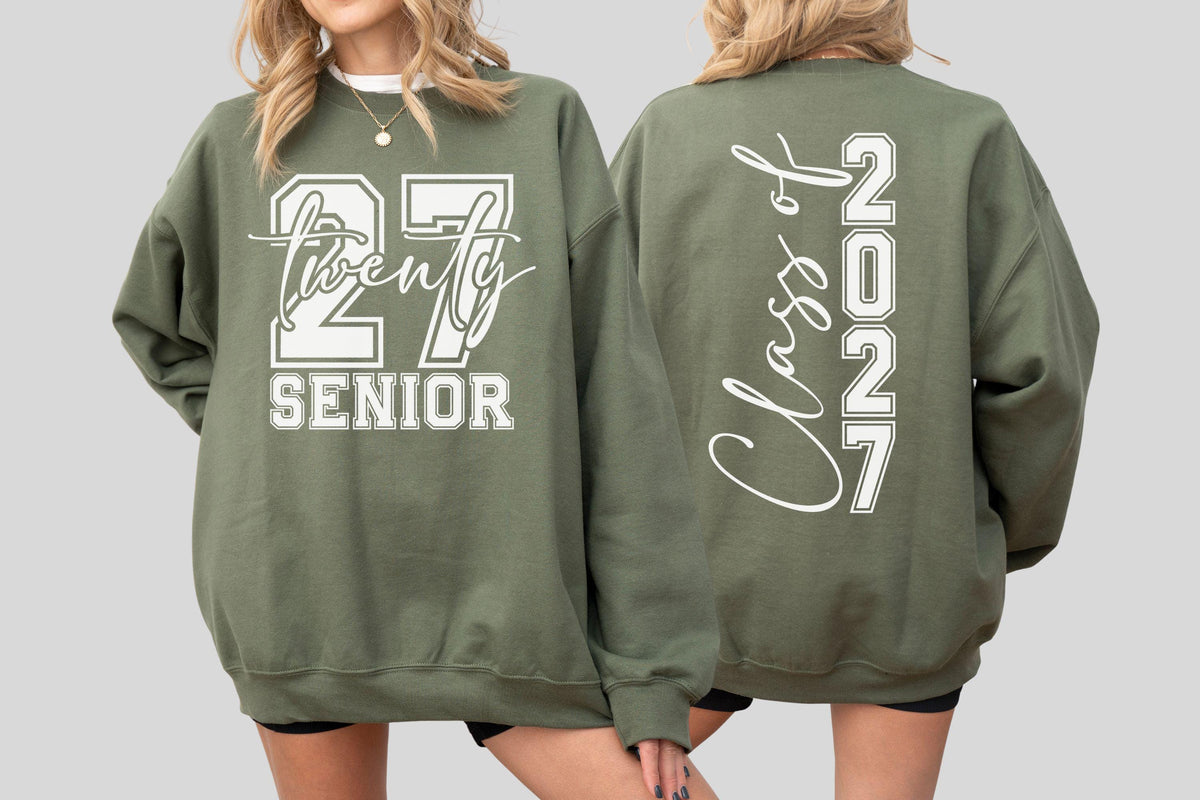 May include: Olive green sweatshirt with white text. The front features "27 Twenty SENIOR" in a bold, collegiate style. The back displays "Class of 2027" vertically. A casual, comfortable garment for graduation.