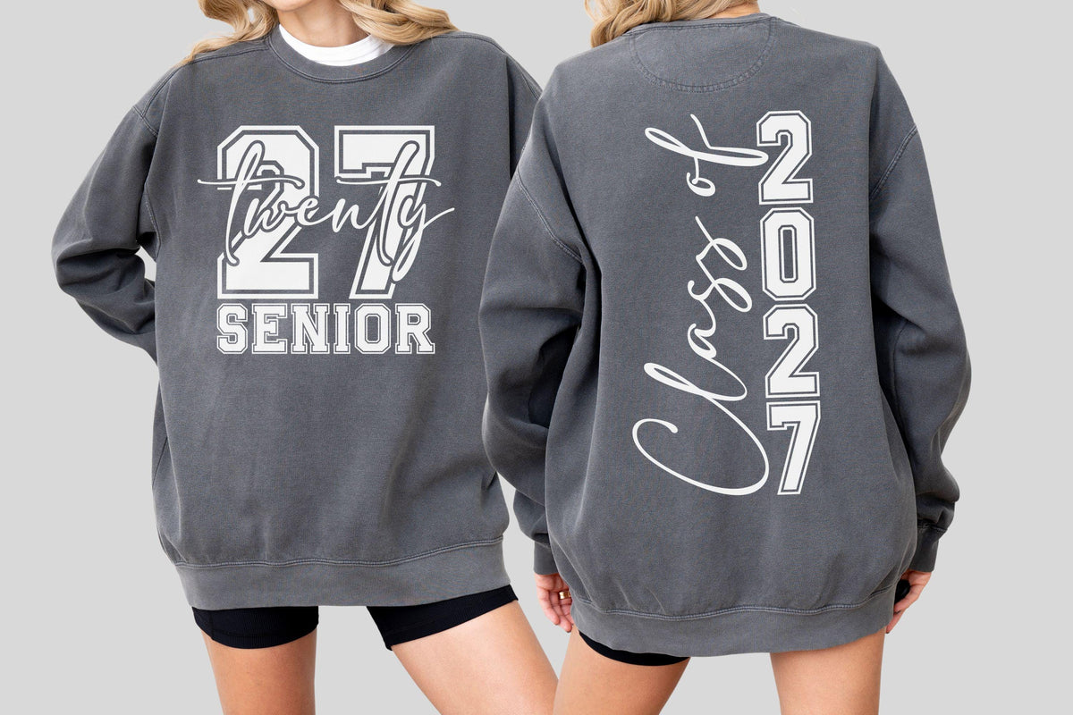 May include: Charcoal gray sweatshirt with white lettering. The front features "27 Twenty SENIOR" in a collegiate font. The back displays "Class of 2027" vertically. A casual, comfortable garment for the graduating class of 2027.