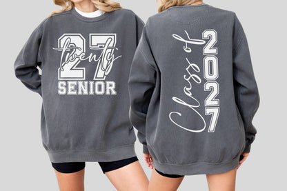 May include: Charcoal gray sweatshirt with white lettering. The front features "27 Twenty SENIOR" in a collegiate font. The back displays "Class of 2027" vertically. A casual, comfortable garment for the graduating class of 2027.