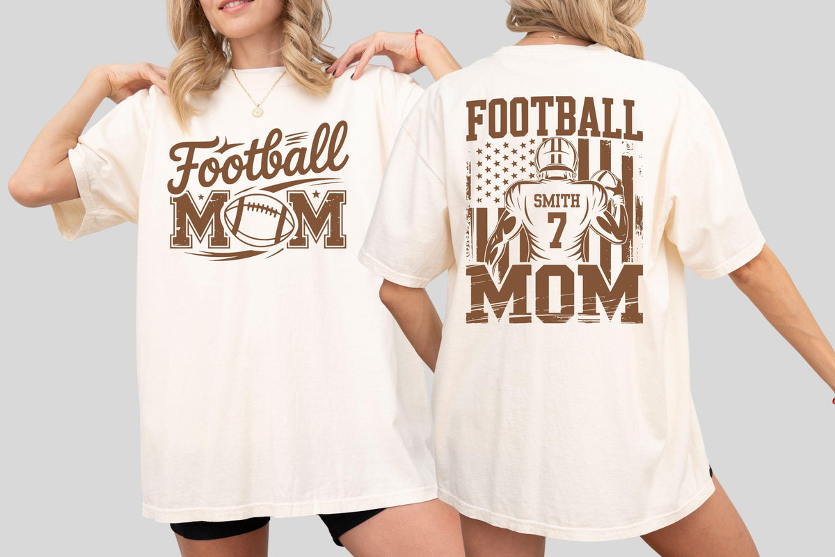 May include: Cream-colored t-shirt with brown text and graphics. The front features "Football Mom" with a football graphic. The back displays "Football Mom" with a football player graphic, the name "Smith" and the number "7".