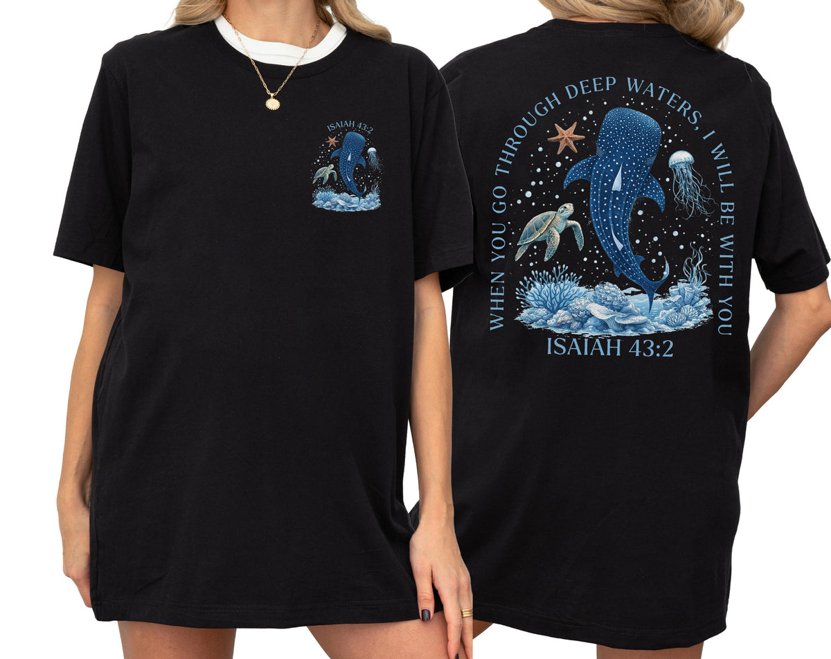 May include: Black t-shirt with a white collar featuring a marine-themed graphic on the front and back. The front graphic shows a whale shark and text. The back graphic includes a whale shark, turtle, jellyfish, and text that reads "WHEN YOU GO THROUGH DEEP WATERS, I WILL BE WITH YOU" and "ISAIAH 43:2".