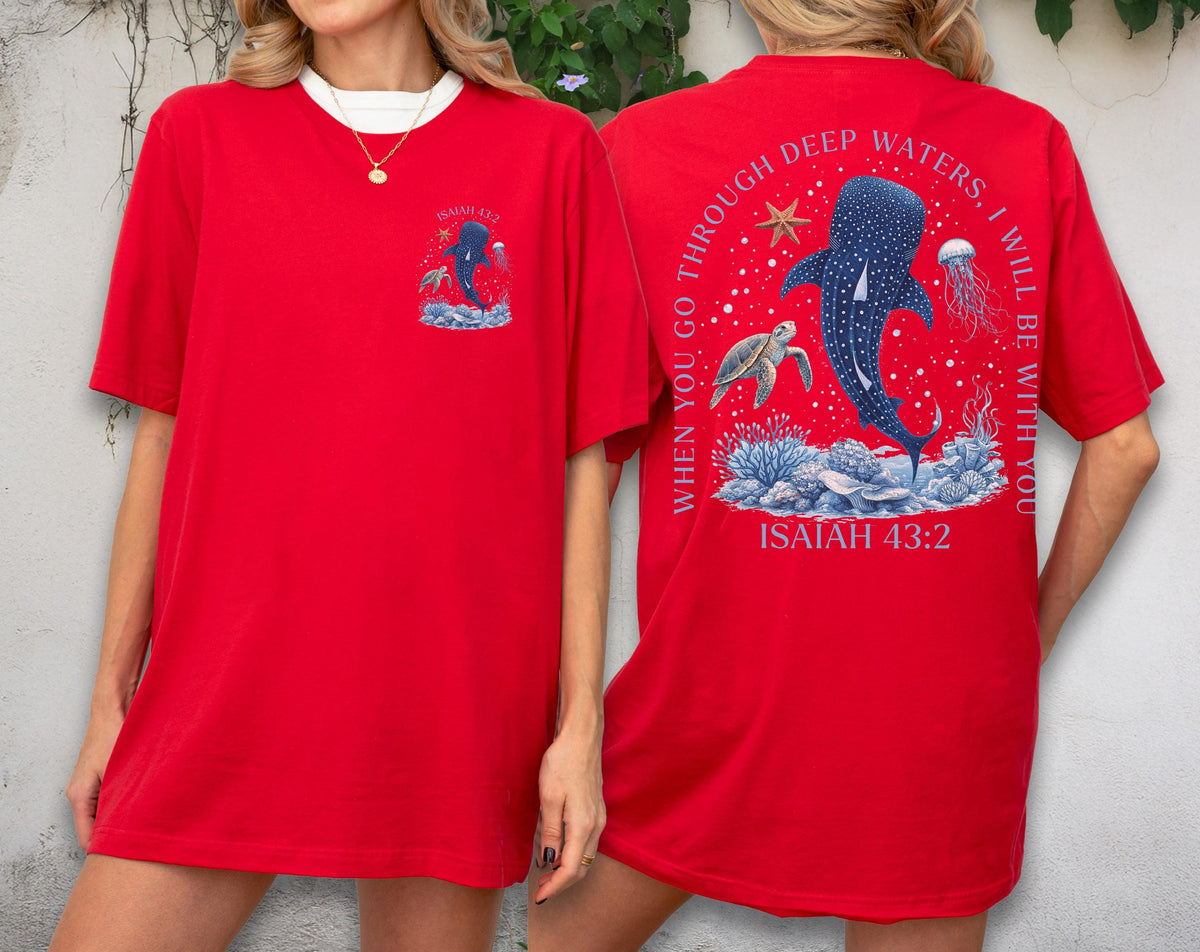 May include: Red t-shirt with a white collar featuring a graphic of a whale shark, turtle, and jellyfish. The back of the shirt has the text "When you go through deep waters, I will be with you" and "Isaiah 43:2".