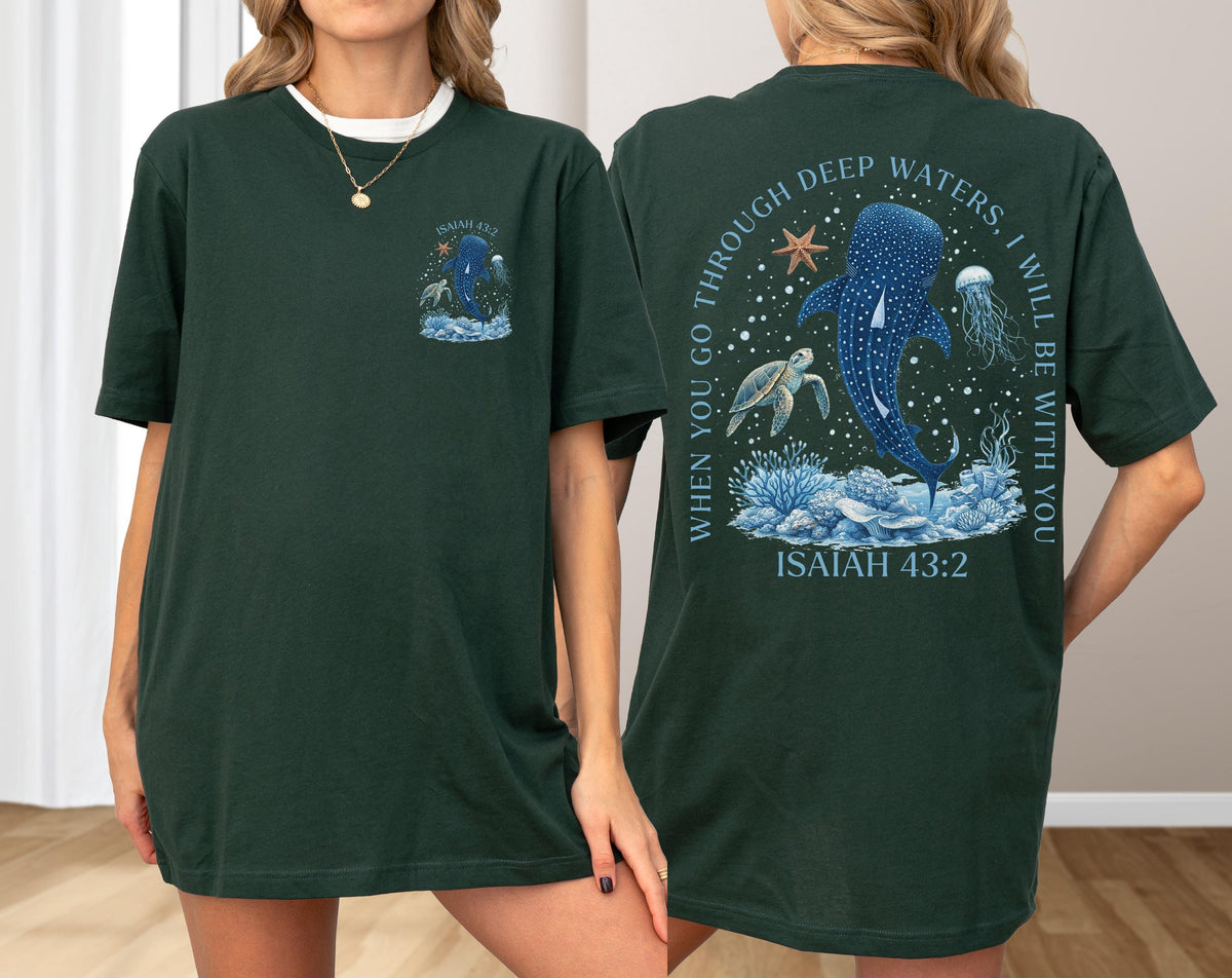 May include: Dark green t-shirt with a marine life design. The front features a whale shark and text. The back has a larger design with a whale shark, turtle, and jellyfish, with the text "WHEN YOU GO THROUGH DEEP WATERS, I WILL BE WITH YOU" and "ISAIAH 43:2".