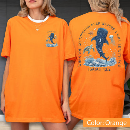 May include: Orange t-shirt with a white collar featuring a marine-themed graphic. The front displays a whale shark illustration with the text "ISAIAH 43:2". The back has a larger design with a whale shark, turtle, jellyfish, and the text "WHEN YOU GO THROUGH DEEP WATERS, I WILL BE WITH YOU, ISAIAH 43:2".