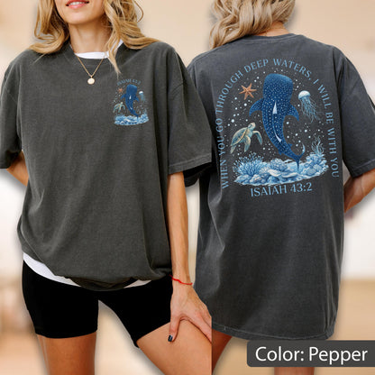 May include: Pepper-colored t-shirt with a marine-themed graphic. The front features a whale shark design with the text "Isaiah 43:2". The back displays the text "When you go through deep waters, I will be with you" with a whale shark, starfish, and jellyfish.