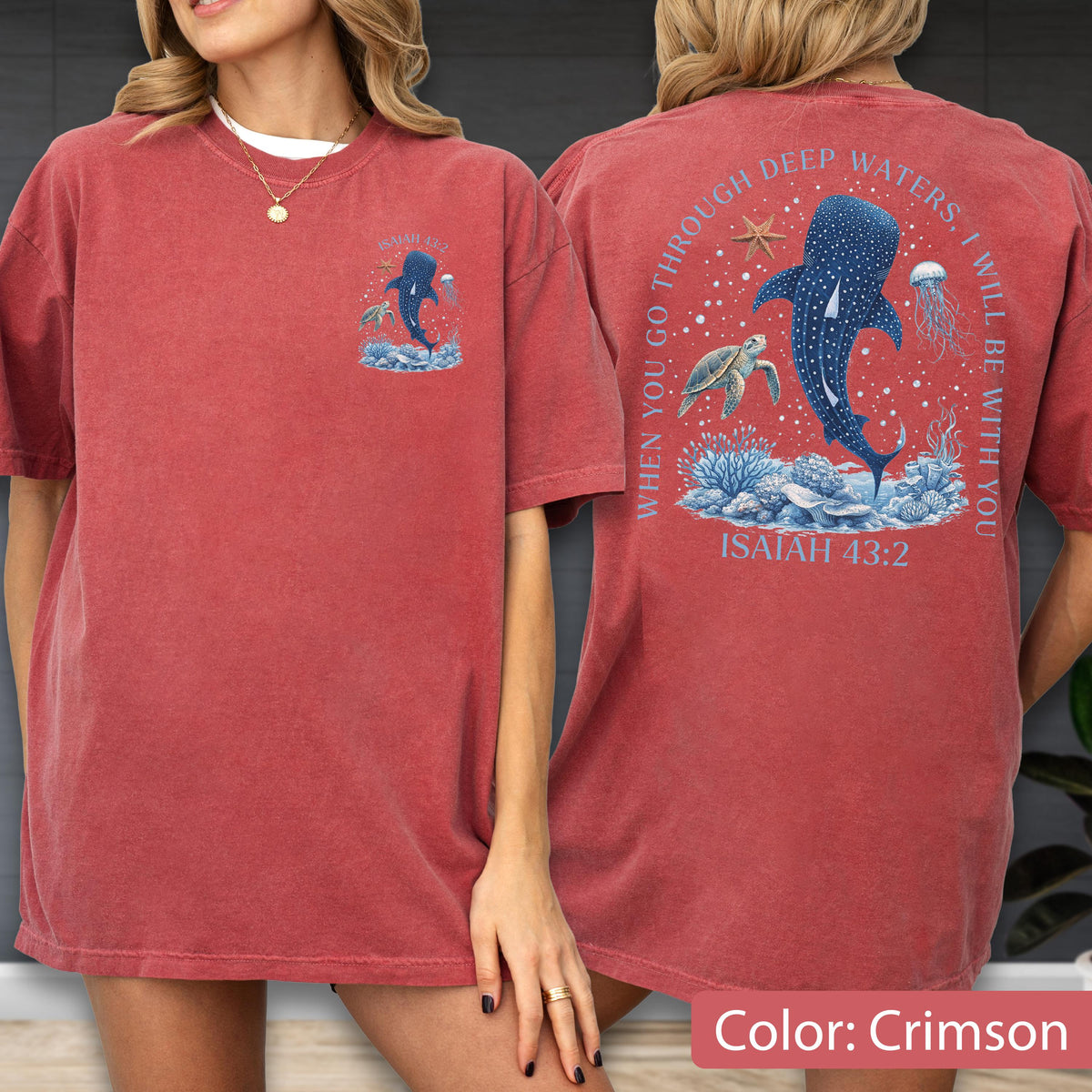May include: Crimson-colored t-shirt featuring a front and back design. The front displays a blue whale illustration with the text "When you go through deep waters, I will be with you. Isaiah 43:2" on the back. The shirt is a short-sleeved, casual style.