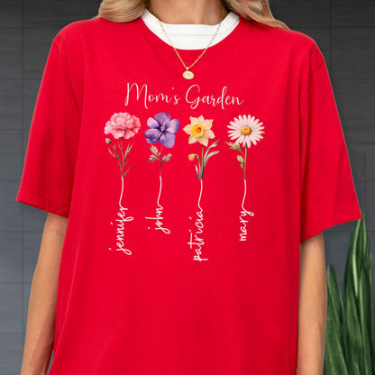 May include: Red t-shirt with the text "Mom's Garden" and four floral illustrations. Each flower has a name written below it: Jennifer, John, Patricia, and Mary. The shirt has a white collar.