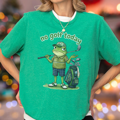 May include: Green t-shirt with the text "no golf today." The shirt features a cartoon frog wearing a golf hat and holding a golf club. A golf bag with clubs is next to the frog. The frog is wearing a green polo shirt and blue plaid shorts.