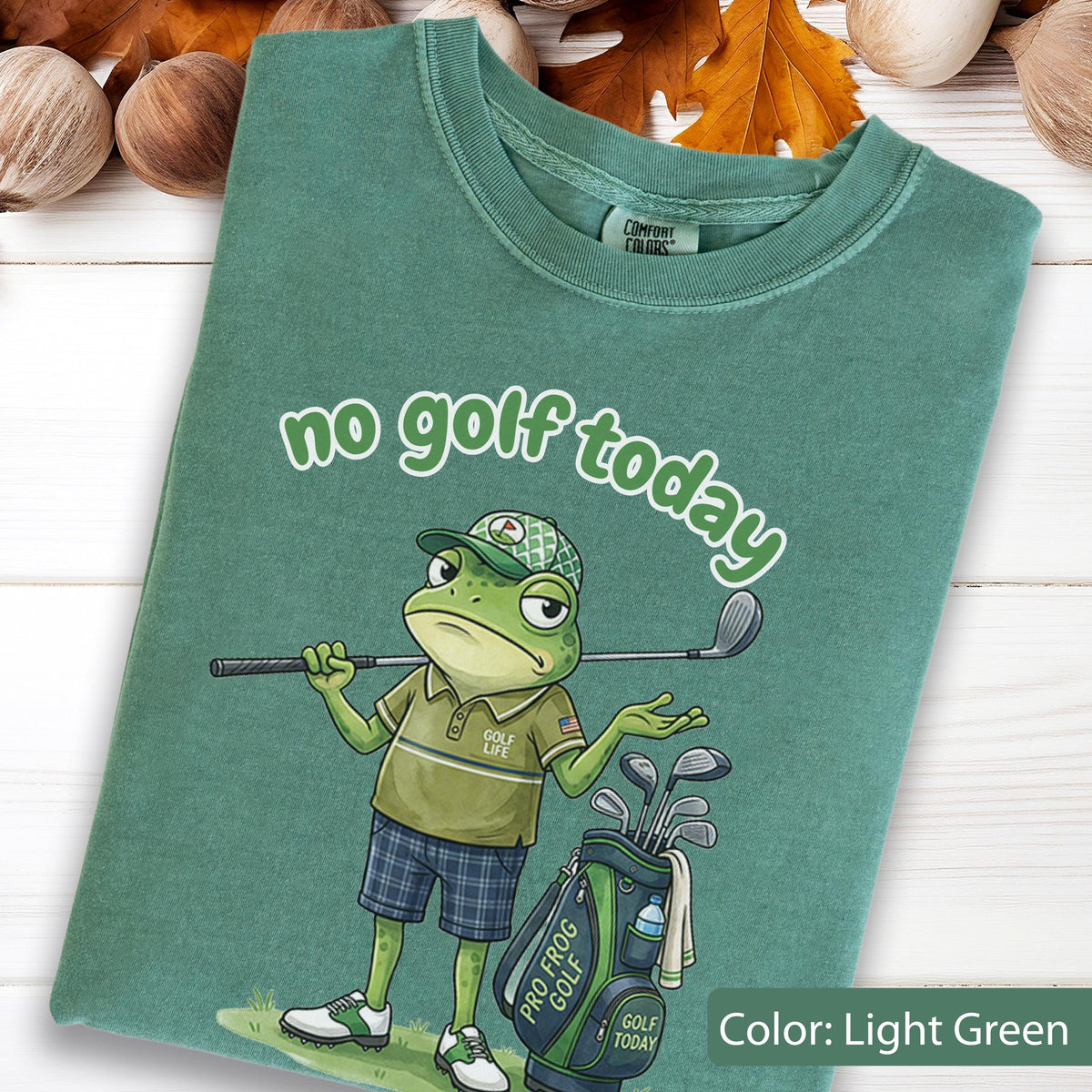 May include: Light green t-shirt with the phrase "no golf today" in white script. The shirt features a cartoon frog golfer with a golf club, golf bag, and the text "Pro Frog Golf".