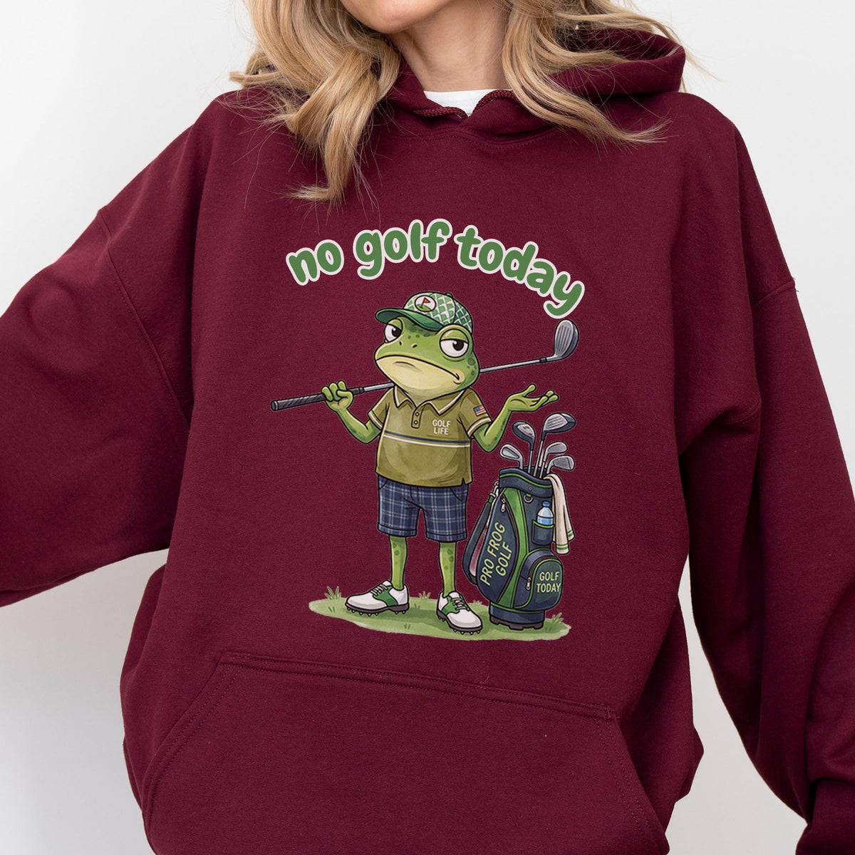 May include: Burgundy hoodie with the text "no golf today" in green script. The hoodie features a cartoon frog wearing a golf hat and holding a golf club. A golf bag with the text "Pro Frog Golf" is also visible.